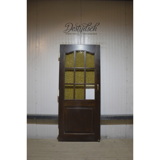 Oude paneeldeur met glas
